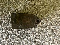 Top view of rusted sad iron base showing tapered point and mounting hole