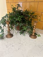 Overall view of brass candlesticks and copper planter with ivy