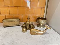 Group shot showing all nine brass items