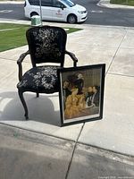 Armchair and framed print together outdoors