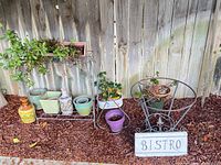 Full lot showing plant stand with pots, table frame and sign