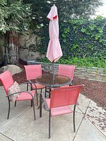 Full view of patio set with table, four chairs, umbrella, base