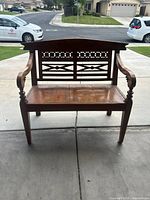 Front view of carved solid wood 2-seater bench