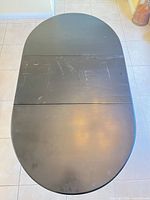 Top view showing black oval surface with scratches