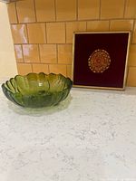 Both items together: green glass bowl and framed textile art