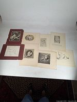 Overview showing eight prints on table