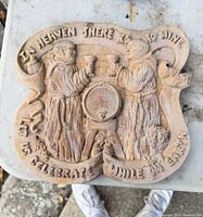 Full view of pottery plaque front showing complete design and inscription