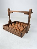 Front angle of charred-wood tray filled with round nuts