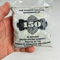 Front view of sealed bag showing printed label and shredded currency inside