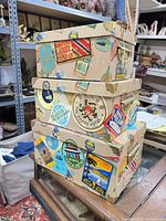 Front view of stacked boxes showing stickers, handles, brass corners