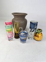 Group of eight items: ceramic vase and seven assorted shot glasses
