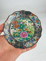 Full view of scalloped porcelain dish showing overall floral design and size reference
