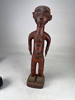 Full frontal view of carved wooden fertility figure