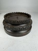 top and side view showing entire candle holder with decorative bands and central spike