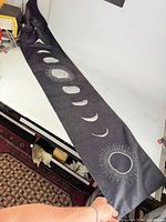 Full length view of black tapestry with moon phases