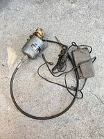 Motor, flexible shaft, and foot pedal laid out on ground