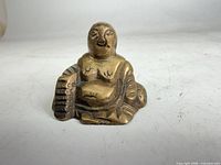 Front view of small solid brass seated Buddha figurine