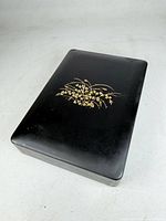 Top view of closed box showing gold floral motif