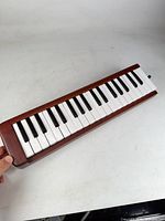 Top view of wooden melodica showing full keyboard and mouthpiece port