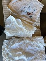 folded tablecloth showing embroidered bouquet and lace detailing