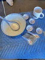 Entire set arranged showing bowl, ladle, spoons, dipping bowls and mug