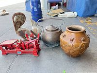Group view of scale, roosters, kettle and jar