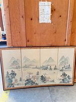 Front view of four-panel landscape painting in wood frame