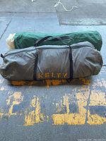 Kelty gray duffel tent bag with green rolled tent bag