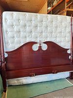 Front view of mahogany headboard with posts and box springs