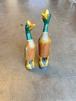 Both carved wooden birds front view