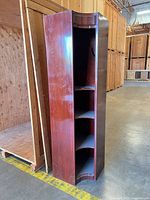 Full view of tall corner cabinet showing overall structure and shelves