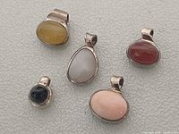 Front view of five gemstone pendants
