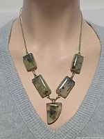 Necklace on bust showing front view and gemstone arrangement