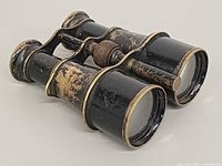 Three-quarter front view showing barrels, bridge, focus knob and wear