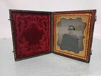 Case open showing ambrotype and red velvet pad