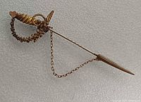 Full view of sword stick pin showing chain and sheath