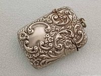 front view of ornate silverplated vesta case