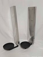 Front view of pair showing steel backplates and black iron candle holders