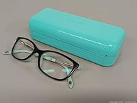 Eyeglasses beside Tiffany blue case