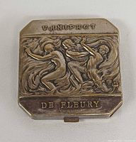 Top view showing embossed Art Deco design and branding