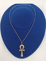 Full view of pendant necklace on display form