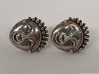 Front view of both silver goddess face stud earrings