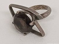 Oblique view showing smoky quartz, triangular frame, 925 mark visible