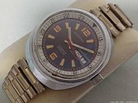 Front view displaying dial, hands, day-date window, two-tone bracelet