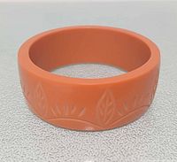 Top view of entire Bakelite bangle showing leaf carving pattern