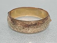 Front view showing floral engraving and hinge