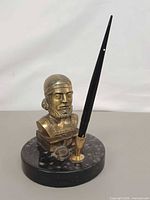 Front view bronze bust on marble base with fountain pen inserted