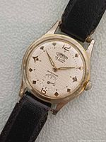 Watch dial and case front showing brand, dial design and wear