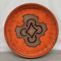 Front view of ceramic platter showing glaze and central motif