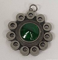 Front view showing green glass cabochon and perforated pewter design